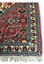 Detailed border of Bijar Poshti Persian rug showing ivory band with floral pattern framed by light blue guard borders.