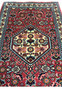 Closeup of ivory diamond medallion on 1'6 x 2'2 Bijar Poshti Persian rug with detailed floral motifs and rich red field.