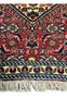 Corner of 1'6 x 2'2 Bijar Poshti Persian rug showing floral border design, ivory fringe, and dense red field.