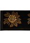 Border detail of modern floral wool rug with golden flower pattern on black field