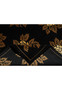 Edge view of modern floral rug with black field and golden border details
