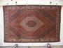 Hand-knotted Persian Bijar rug 6'8 x 10'6 displayed hanging, showing intricate floral patterns