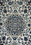 Medallion close-up of 2'9 x 4'10" Ivory Nain Persian Rug with beige, blue, and navy petals