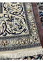 Backside of 6'7 x 6'7 Square Persian Nain Rug showing fine knot density, ivory foundation, and hand-knotted craftsmanship