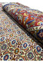 Rolled Persian Moud rug highlighting pile quality and border design
