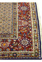 Close-up of Persian Moud rug border with terracotta and floral designs