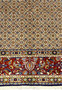 Lower border of Persian Moud rug with red, navy, and olive floral motifs