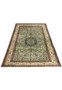 Angled laid-down view showing entire hand-knotted Persian Tabriz rug in green and ivory tones