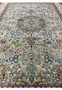 Wide midfield view of Persian Tabriz rug highlighting the detailed medallion and floral design on a soft sage-green background