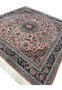 Angled view of Persian Tabriz rug showing pile texture and rich salmon and navy color contrast