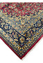 Angled corner view highlighting the rug’s dense pile, fine knotting, and aged patina in traditional Isfahan artistry.