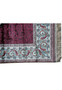 Rolled silk oriental rug with burgundy and sky-blue tones highlighting sheen and texture Rolled silk oriental rug with burgundy and sky-blue tones highlighting sheen and texture