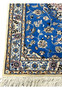 Ivory border with silk floral rosettes and vines on Persian Nain 6LA Runner, wool and silk texture visible.