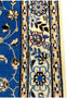 Floral border section of Persian Nain 6LA Runner, showcasing ivory ground and blue silk outlines