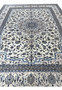 Front angled view of 10' x 13'2 Persian Nain 9LA Rug displaying balanced ivory field and blue floral composition.