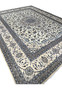 Angled view of 10' x 13'2 Persian Nain 9LA Rug revealing depth of pile and luminosity of silk on ivory and blue motifs.