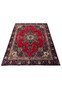 Hand-knotted 8'5" x 12'9" Persian Tabriz rug laid flat showing red floral field and detailed navy border