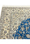 Ivory floral border with blue detailing of Persian Nain 6 LA rug showing fine hand-knotted weave.