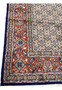 Detailed Herati fish pattern with blue rosettes and olive-green leaves on ivory field of Moud rug.
