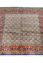 Hand-knotted Persian Moud rug laid flat, displaying balanced lattice pattern and coral-red border.