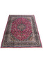 Top full view of Persian Mashad red wool rug showing floral medallion and navy borders.