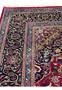 Border section of Persian Mashad rug with deep navy ground and scrolling floral pattern.