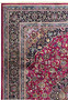 Upper border close-up of Persian Mashad rug with navy vines, sky blue accents, and floral scrolls.