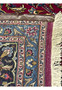 Backside of 9'9x12'8 Persian Mashad rug showing fine knotting and detailed craftsmanship with blue and red tones.