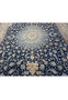 Midfield of 14x25'6 Nain Persian rug showing floral arabesque design in navy and light blue.