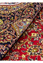 Rolled Persian Kashan rug 9x13 showing wool pile texture and handmade knots