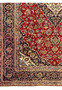 Close up of color defect area on Persian Kashan rug showing light faded border