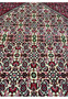 closeup of 10x13 Bijar Persian rug medallion showing intricate red, ivory, and green motifs