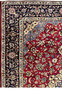 Border of 8'5 x 11'8 Persian Isfahan rug showing navy vines, ivory outlines, and detailed blossoms.