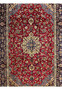 Central field of 8'5 x 11'8 Persian Isfahan rug showing red wool background and floral medallion symmetry.
