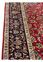 Side border of 8'5 x 11'8 Persian Isfahan rug showing navy floral vines and ivory guard stripes.