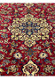 Closeup of 8'5 x 11'8 Persian Isfahan rug highlighting red wool field and multicolor floral details