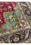 Detailed corner view of the 9'9 x 12'4 vintage Persian Tabriz rug showing turquoise corner spandrel, floral motifs, and navy border with fine wool pile.