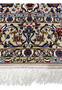 Woven Davari signature with Iranian flag details on the lower border of the Persian Isfahan rug.