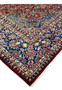 Edge shot of the vintage Najafabad Persian rug showing the border design, fringe, and wool pile texture.