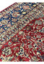 Detailed view of the floral border and red field of a vintage Najafabad Persian rug with classic creamy and blue accents.