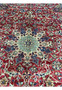 Close-up of the central medallion on a vintage 9x14'5 Najafabad Persian rug showing detailed floral motifs on a red field.