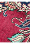 Closeup of patina wear on 10x13 vintage Persian Tabriz rug showing low-pile texture and softened red field with floral motifs.