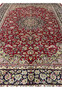 Color closeup of red field Persian Isfahan rug showing detailed floral weaving