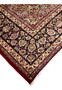 Corner and edge detail of Persian Isfahan rug with cream and navy floral border