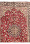 Upper section of red Isfahan rug with fine floral patterns and curved medallion details