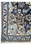 Ivory border detail of 3x5 Persian Nain rug with navy outlines, sky blue flowers, beige scrolls, and soft gold highlights