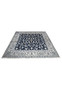 Hand knotted square Persian Nain rug laid flat showing balanced floral symmetry and rich navy and ivory color contrast