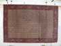 Hanging full-view 7x9'8 allover Bijar Persian Iron Rug with burgundy field, cream floral lattice, and detailed red–navy borders