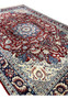 Angled view of an 8'5 x 11'8 Persian Isfahan rug showing depth of pile, crisp floral detailing, and elegant border framing