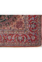 Close-up of edge and corner of Persian Isfahan rug showing precise hand-knotted finish and border details